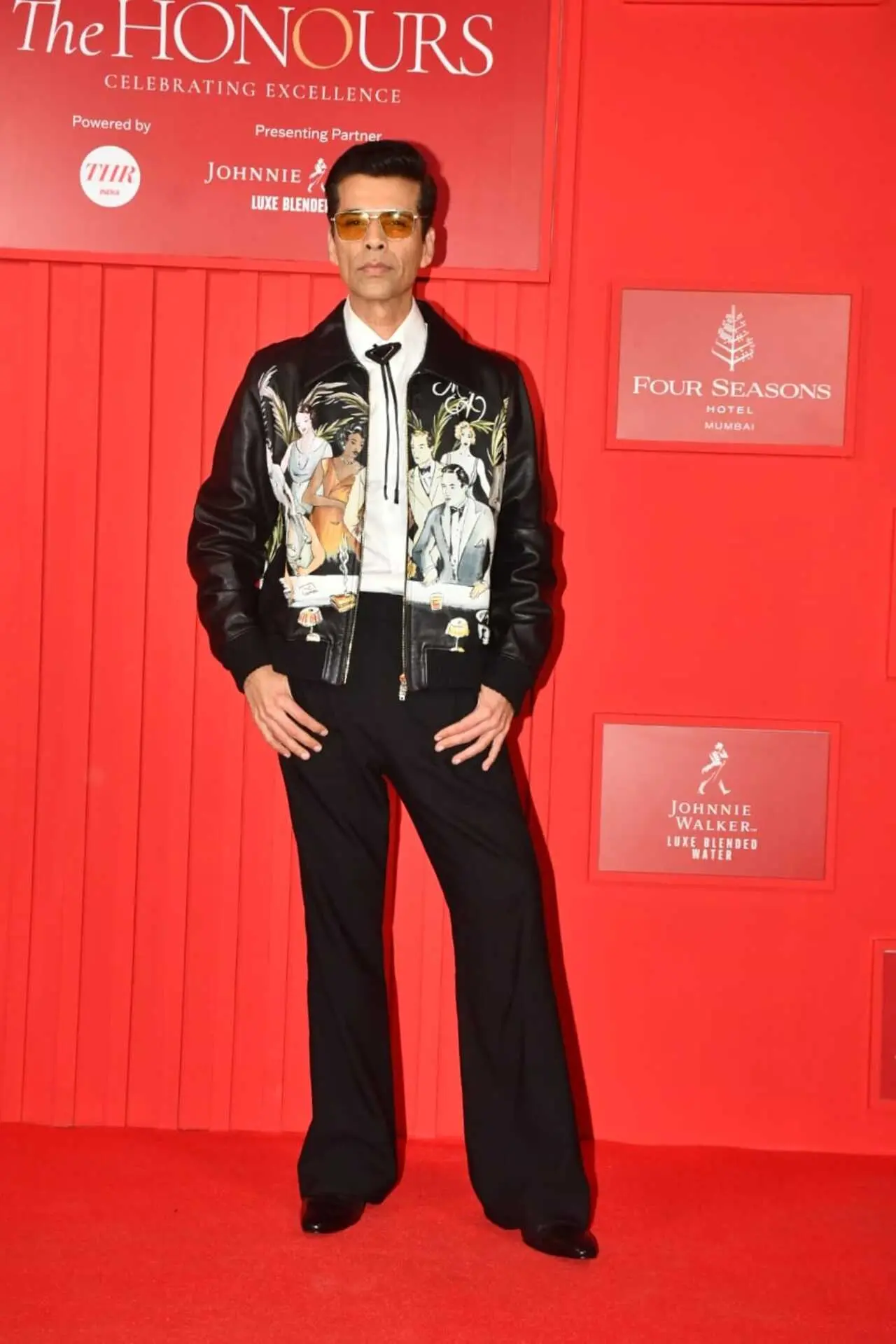 Karan Johar made a statement in his black printed jacket over bootycut jeans as he walked the red carpet at an event.